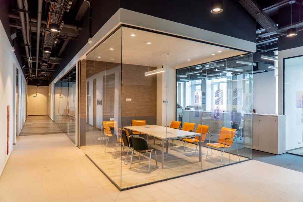 یک اتاق کنفرانس شفاف، با دیوارهای شیشه‌ای بدون قاب، شفافیت در ارتباطات و همکاری را تقویت می‌کند و در عین حال نور و مناظر طبیعی را به حداکثر می‌رساند.